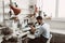 Focused on his job. Side view of a male jeweler looking at the ring through microscope in a workshop.