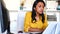 Focused hispanic business woman working with computer in modern office