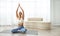 Focused Hispanic woman practicing the lotus pose with hands in namaste during a tranquil yoga