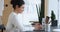 Focused indian businesswoman sit at office workplace typing on laptop