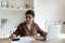 Focused Indian woman calculates expenses paying bills and taxes online