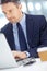 Focused on the job at hand. Handsome mature businessman using his laptop while seated at his desk.