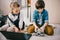 focused kids programming robot while sitting on floor