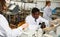 Focused lab technicians man writing report of chemical experiments