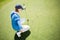 Focused lady golfer kneeling on the putting green