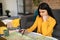 Focused lady planning future journey with map, choosing best travel routes and preparing for trip at home