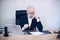 A focused lawyer sits in the office and works with documents contract papers on wood table.