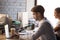 Focused male employee busy working at laptop in coworking office