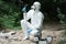 focused male scientist in protective suit and mask examining stone while holding by tweezers