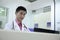 Focused Male veterinarian looking at computer screen