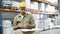 Focused male worker in helmet signing documents.