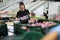 Focused male worker working at fruit warehouse carrying box with mangos