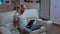 Focused man with beard sitting on couch in front of television