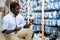 Focused man choosing light bulbs in household goods store