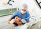 Focused man dentist in a protective mask treats a woman patient