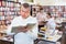 Focused man looking for information in books in bookstore