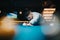 Focused man playing billiards in a pool hall with ambient lighting