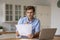 Focused man reading letter, working with correspondence at home