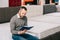 focused man reading notes in notebook in furniture shop with arranged