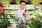 Focused man reading product label while choosing fertilizers at gardening store