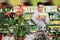 Focused man reading product label while choosing fertilizers at gardening store