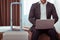 Focused man in strict office costume being ready for check out in a hotel