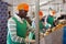 Focused man working on citrus sorting line at warehouse, checking quality of tangerines