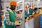 Focused man working on citrus sorting line at warehouse, checking quality of tangerines