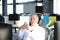 Focused mature businessman deep in thought while sitting at a table in modern office