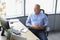 Focused mature businessman deep in thought while sitting at a table in modern office