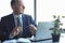 Focused mature businessman deep in thought while sitting at a table in modern office