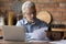 Focused middle aged man doing financial paperwork at home.