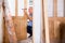 Focused middle-aged repairman checking a doorknob on a door in the house