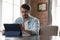 Focused millennial freelance employee man in casual using tablet computer