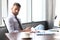 Focused modern businessman working and taking notes in his modern office