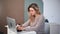 Focused modern woman chatting surfing internet use laptop sitting on desk. Medium shot on RED camera