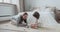 Focused mom teaching son kid constructing brick blocks wooden architecture at bedroom