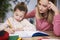 Focused mother helping child with homework