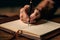 Focused note-taking, Close-up of man\\\'s hand writing in his notebook