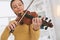 Focused photo on female hands that holding violin