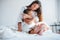 Focused photo. Young mother with her daugher have beauty day indoors in white room