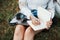 Focused photo. Young woman have weekend and sits in the park at daytime