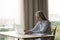 Focused positive elderly lady using laptop computer indoors