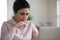 Focused pretty Indian business woman using laptop at desk