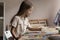 Focused pupil girl drawing on canvas at table in classroom