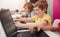 Focused schoolboy working on laptop during school lesson