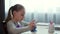 Focused schoolgirl using smartphone at home