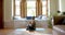 Focused senior biracial woman meditating on yoga mat at home