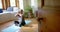 Focused senior biracial woman meditating on yoga mat at home