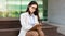 Focused serious pretty young woman secretary manager in suit, glasses write at clipboard work with documents